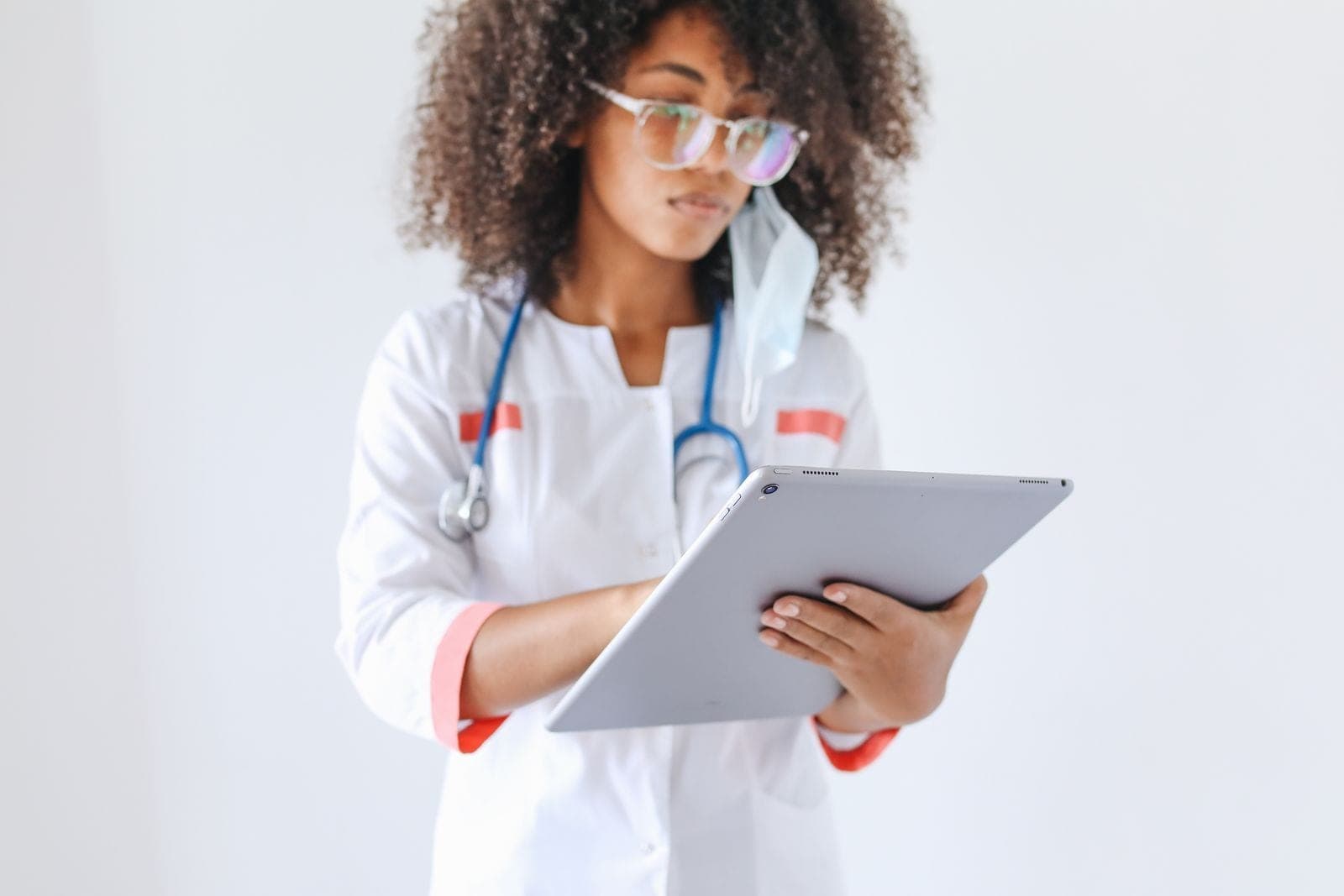 A healthcare professional using a digital tablet